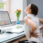 Person Having Backpain While Working on Computer