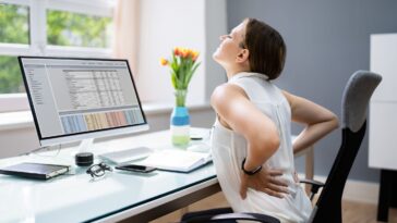 Person Having Backpain While Working on Computer